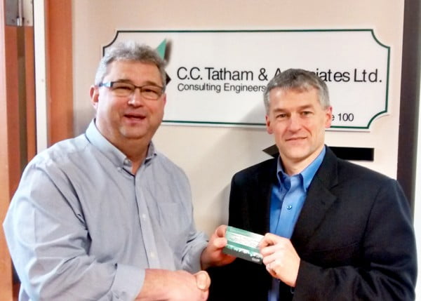 SUBMITTED PHOTO Dan Landry, the city's economic development manager, presents Eli Young concert tickets to Tim Collingwood, of C.C. Tatham and Associates. A second set of tickets to Paul Zerdin Live were won by David Smith, of Oro Design and Manufacturing. Both businesses participated in a business survey and there is still time for area businesses to win.