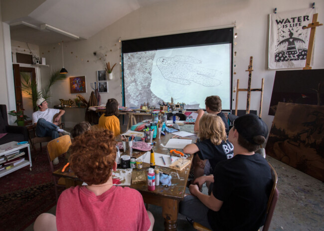 Skate deck paint workshop with BONES featuring the projector & screen purchased through the CDC’s Community Capacity Building Fund grant