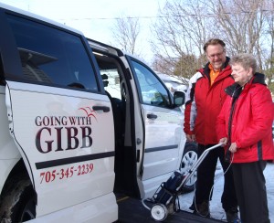 Brian Gibb lends a hand to Liz Gibb as she makes her way up the ramp into a wheelchair-accessible van. Going with Gibb is an accompaniment service in which Gibb offers rides – and companionship – to people needing a drive to appointments, chores or special events.